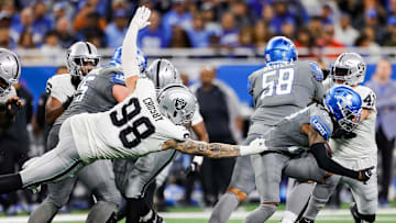 Detroit Lions running back Jahmyr Gibbs (26) is tackled by Las Vegas Raiders defensive end Maxx Crosby (98) during the second half at Ford Field in Detroit on Monday, Oct. 30, 2023.