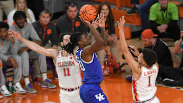Dec 3, 2024; Clemson, South Carolina, USA; Kentucky guard Otega Oweh (00) makes a shot near Clemson guard Chase Hunter (1) during the first half at Littlejohn Coliseum. Mandatory Credit: Ken Ruinard-Imagn Images