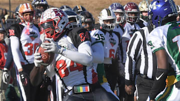 South team wide receiver Mikkel Skinner (84) of Riverside High catches a pass near North team defensive back Devine Ohiaeri (35) of Southeast Raleigh High and North team defensive back AJ Graham (19) of Moorsville High during the first quarter of the 2024 Shrine Bowl of the Carolinas at Viking Stadium in Spartanburg, S.C. Saturday, December 21, 2024.