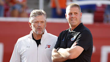 Aug 31, 2023; Salt Lake City, Utah, USA; Utah Utes head coach Kyle Whittingham, left,  and Florida Gators head coach Billy Napier get together prior to their game at Rice-Eccles Stadium. Mandatory Credit: Jeff Swinger-Imagn Images