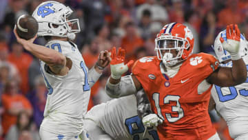 Nov 18, 2023; Clemson, South Carolina, USA; North Carolina Tar Heels quarterback Drake Maye (10) throws against Clemson Tigers defensive tackle Tyler Davis (13) during the third quarter at Memorial Stadium. Mandatory Credit: Ken Ruinard-USA TODAY Sports