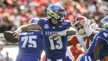 Kentucky quarterback Devin Leary (13) passes near Clemson defensive end Justin Mascoll (7) during the first quarter of the TaxSlayer Gator Bowl at EverBank Stadium in Jacksonville, Florida, Friday, December 29, 2023.