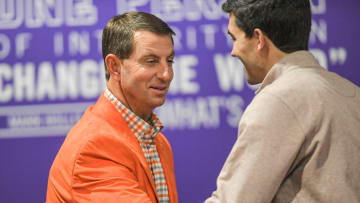 Clemson Head Football Coach Dabo Swinney shakes hands with Director of Athletics Graham Neff talks during a press conference in Clemson, S.C. Wednesday, February 2, 2022. 