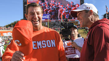 Nov 26, 2022; Clemson, SC, USA; Clemson head coach Dabo Swinney, left, and South Carolina head coach Shane Beamer talk before the game at Memorial Stadium in Clemson, S.C. Saturday, Nov. 26, 2022.    Mandatory Credit: Ken Ruinard-Imagn Images