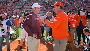 Nov 26, 2022; Clemson, SC, USA; Clemson head coach Dabo Swinney, right, and South Carolina head coach Shane Beamer talk before the game at Memorial Stadium in Clemson, S.C. Saturday, Nov. 26, 2022.    Mandatory Credit: Ken Ruinard-Imagn Images
