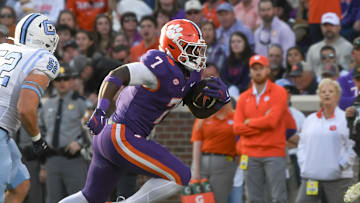 Nov 23, 2024; Clemson, South Carolina, USA; Clemson Tigers running back Phil Mafah (7) runs by The Citadel Bulldogs linebacker Camden Gray (52) during the first half at Memorial Stadium. 