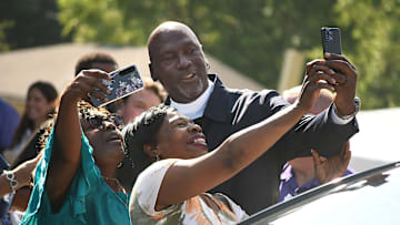 Michael Jordan takes a few photos with friends outside of The Michael Jordan Family Medical Clinic led by Novant Health. After taking part in a ribbon cutting ceremony for the new clinic opening off of Greenfield Street Tuesday May 7, 2024 in Wilmington, N.C. KEN BLEVINS/STARNEWS
