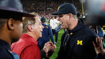 Michigan coach Jim Harbaugh shakes hands with Alabama coach Nick Saban after the Wolverines'  27-20 overtime win over the Crimson Tide at Rose Bowl Stadium in Pasadena, Calif., on Jan. 1, 2024.