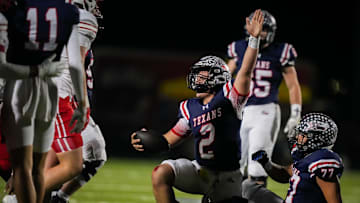 Wimberley QB Cody Stoever motions for a first down during the 2023 UIL (Texas) state  semifinals on Dec. 8, 2023.