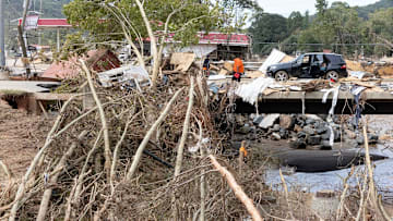Sep 30 2024; Swannanoa, NC, USA; People bring gas and other supplies across the Whitson Avenue bridge over the Swannanoa River that was heavily damaged by trees and a shipping container as the recovery from flooding caused by Hurricane Helene continues. Helene’s swath of destruction brought historic rainfall, flooding, power outages and 140-mile-an-hour winds across the Southeast. North Carolina that bore the brunt of damage, with vast swaths of cities like Asheville underwater, residents