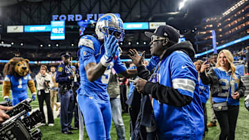 Detroit Lions receiver Jameson Williams meets Hip-hop artist Flavor Flav during an NFL game against the Green Bay Packers