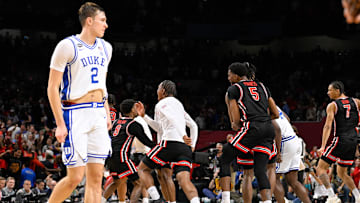 Flagg leaves the court as Houston players celebrate their comeback victory in the Final Four on Saturday in San Antonio.