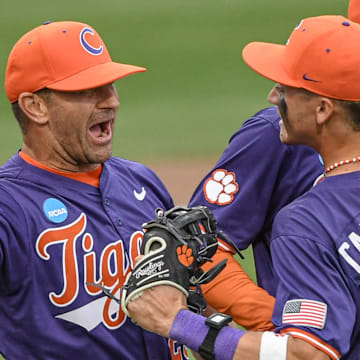 Jun 1, 2024; Clemson, South Carolina, USA; Clemson Tigers head coach Erik Bakich and outfielder Cam Cannarella (10) celebrate after defeating the Coastal Carolina Chanticleers at the Clemson Regional at Doug Kingsmore Stadium. 