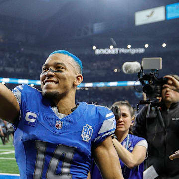 Detroit Lions wide receiver Amon-Ra St. Brown celebrates the 31-23 win over the Tampa Bay Buccaneers in the NFC divisional round at Ford Field in Detroit on Sunday, Jan. 21, 2024. His hair is dyed blue.