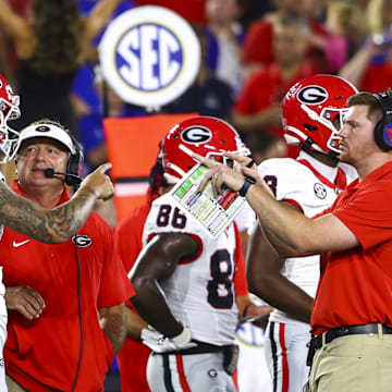 Sep 14, 2024; Lexington, Kentucky, USA; Georgia Bulldogs head coach Kirby Smart talks to quarterback Carson Beck (15) on the sidelines during the first quarter against the Kentucky Wildcats at Kroger Field. Mandatory Credit: Carter Skaggs-Imagn Images