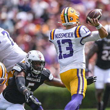 Louisiana State University quarterback Garrett Nussmeier (13) passes near South Carolina edge Kyle Kennard (5) during the second quarter at Williams-Brice Stadium in Columbia, S.C. Saturday, September 14, 2024.