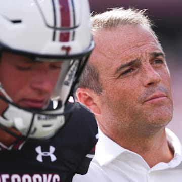 Sep 14, 2024; Columbia, South Carolina, USA; South Carolina Gamecocks head coach Shane Beamer listens to the alma mater with punter Kai Kroeger (39) after a game against the LSU Tigers at Williams-Brice Stadium.  Mandatory Credit: Ken Ruinard/USA TODAY Network via Imagn Images