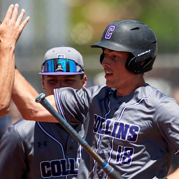 Fort Collins' Max Bronson celebrates with his team after scoring a run during a Colorado Class 5A state baseball tournament game against Regis Jesuit.