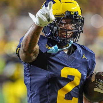 Michigan defensive back Will Johnson (2) celebrates after returning an interception for a touchdown against Fresno State during the second half at Michigan Stadium in Ann Arbor on Saturday, Aug. 31, 2024.