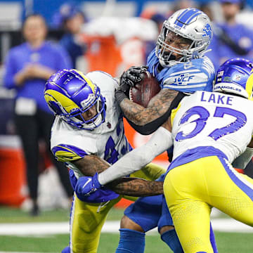 Detroit Lions running back David Montgomery runs against Los Angeles Rams safety Quentin Lake during the first half of the NFC wild-card game at Ford Field in Detroit on Sunday, Jan. 14, 2024.