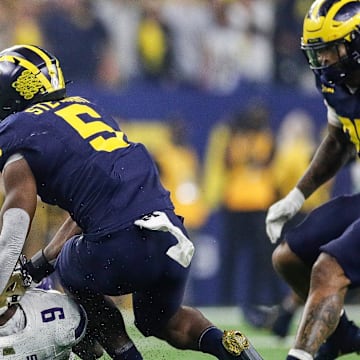 Michigan defensive end Josaiah Stewart tackles Washington quarterback Michael Penix Jr. during the first half of the national championship game at NRG Stadium in Houston, Texas on Monday, Jan. 8, 2024.