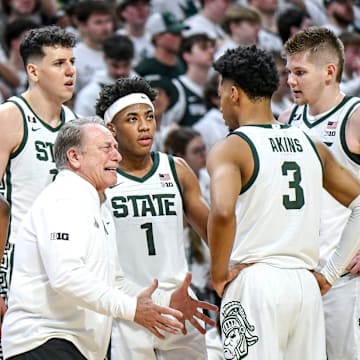 Michigan State coach Tom Izzo talks with his team during a timeout.
