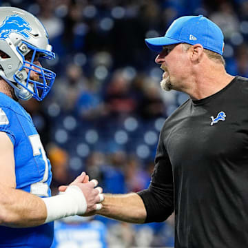 Detroit Lions head coach Dan Campbell shakes hands with center Frank Ragnow (77) warm up before the game between Detroit Lions and Chicago Bears at Ford Field in Detroit on Thursday, Nov. 28, 2024.