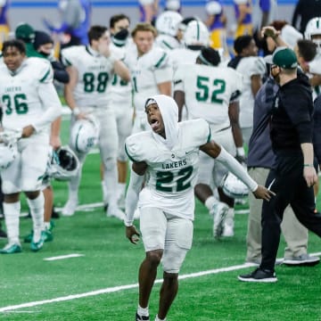 West Bloomfield defensive back BJ Rankin (21) and Maxwell Hairston (22) celebrate the 41-0 win over Davison during the MHSAA Division 1 final at Ford Field, Saturday, Jan. 23, 2021.