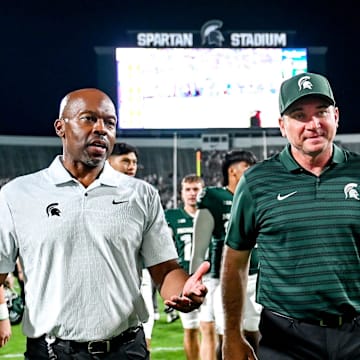 Michigan State football coach Jonathan Smith, right, talks with athletic director Alan Haller after MSU's victory over Florida Atlantic on Friday, Aug. 30, 2024, at Spartan Stadium in East Lansing.