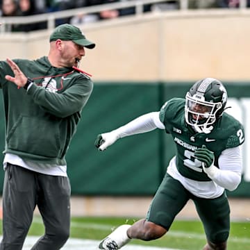 Michigan State's Khris Bogle, right, runs a drill with rush ends coach Chad Wilt during the Spring Showcase on Saturday, April 20, 2024, at Spartan Stadium in East Lansing.