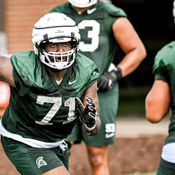 Michigan State's Kristian Phillips runs an offensive line drill during the first day of football camp on Tuesday, July 30, 2024, in East Lansing.