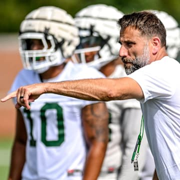 Michigan State's defensive coordinator Joe Rossi works with the defense during the first day of football camp on Tuesday, July 30, 2024, in East Lansing.