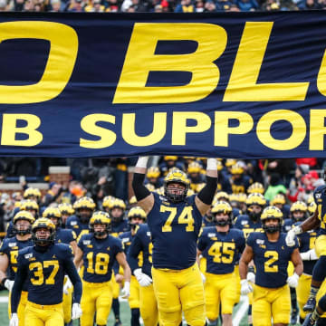 Michigan players jump up to touch the banner as they take the field for the Ohio State game at Michigan Stadium, Saturday, Nov. 30, 2019.

Go Blue Michigan Flag