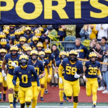 Michigan takes the field ahead of the Maryland game at Michigan Stadium in Ann Arbor on Saturday, Sept. 24, 2022.

09242022 Umfbextra 3 m go blue, michigan flag