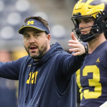 Michigan quarterbacks coach Kirk Campbell talks to players during open practice at NRG Stadium in Houston, Texas on Saturday, Jan. 6, 2024.