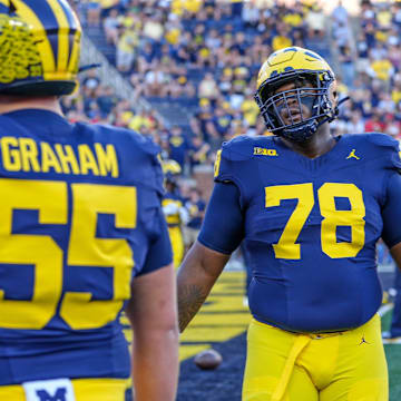 Michigan defensive linemen Mason Graham (55) and Kenneth Grant (78) warm up before the start of the game against Fresno State at Michigan Stadium in Ann Arbor on Saturday, Aug. 31, 2024.