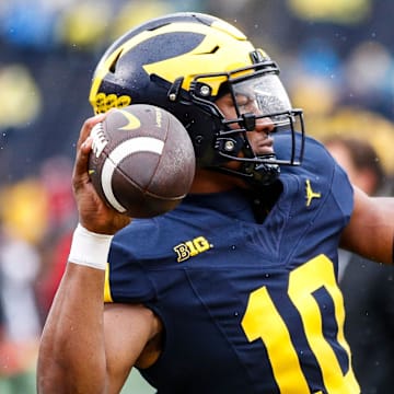 Michigan quarterback Alex Orji (10) warms up before the Indiana game at Michigan Stadium in Ann Arbor on Saturday, Oct. 14, 2023.