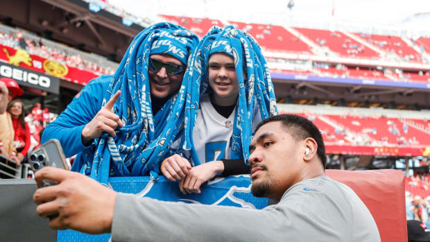 Detroit Lions offensive tackle Penei Sewell takes a selfie with Zach Kelsey and his son Sawyer, 13, both of Twin falls, Idah