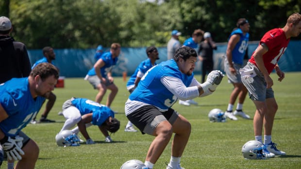 Lions offensive lineman Penei Sewell stretches during the organized team activities in Allen Park on Thursday, May 23, 2024.