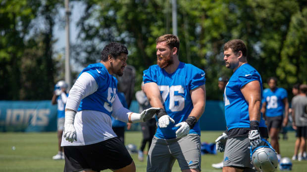 Lions offensive lineman Penei Sewell (58) practices football maneuvers with Connor Galvin (76) during the organized team acti