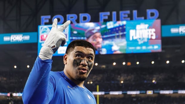 Detroit Lions offensive tackle Penei Sewell signals for two more wins as he celebrates the 31-23 victory over the Tampa Bay B