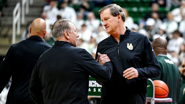 Michigan State's head coach Tom Izzo, left, and Oregon's head coach Dana Altman shake hands before the game on Saturday, Feb.