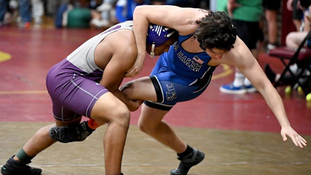 Wrestlers from Cypress Lake (left) and Ida Baker (right) grapple during the LCAC Wrestling Championships on Feb. 4, 2023.