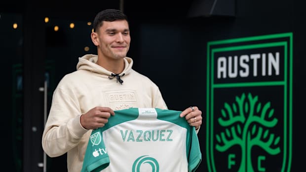 Brandon Vazquez holds up an Austin FC kit. 