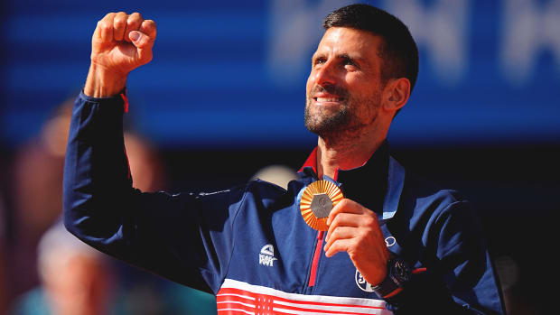 Novak Djokovic holding his gold medal in Paris.