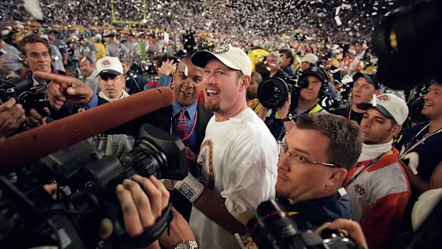 Trent Dilfer surrounded by people on the field after winning the Super Bowl