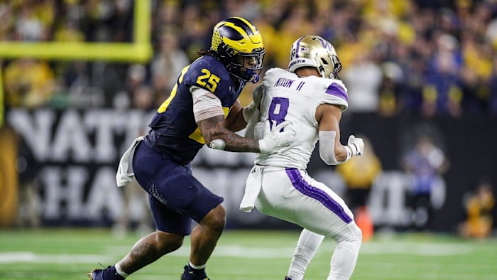 Michigan linebacker Junior Colson tackles Washington running back Will Nixon during the second half