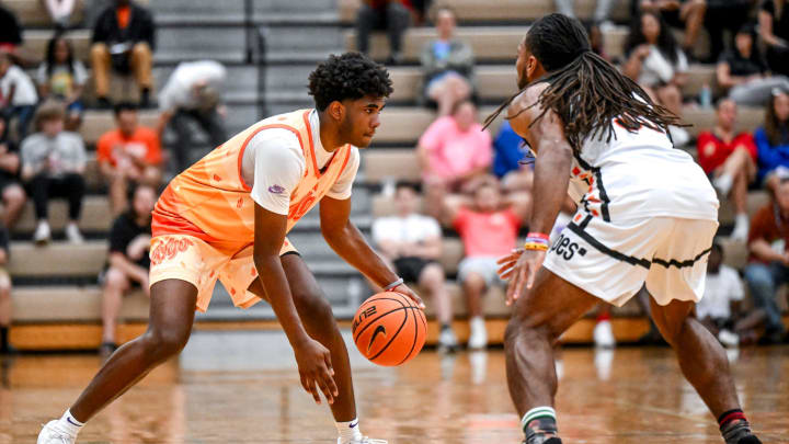 Michigan State freshman and Team Faygo's Jase Richardson, left, moves the game against Team Snipes in the game on Tuesday, June 25, 2024, during the Moneyball Pro-Am at Holt High School.