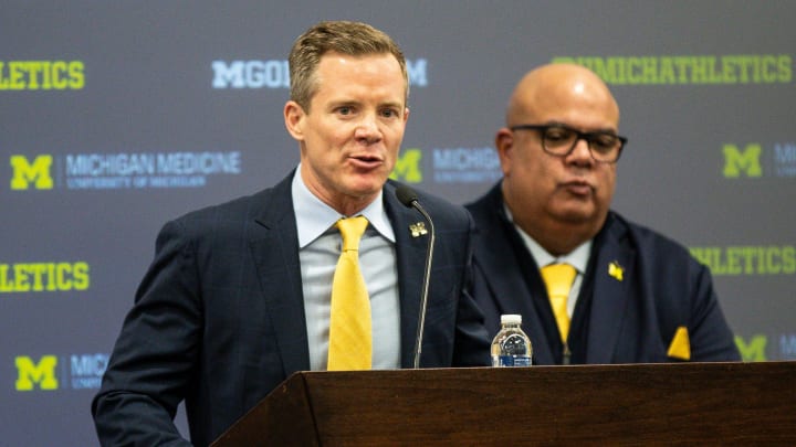 Michigan coach Dusty May answers a question next to athletic director Warde Manuel during an introductory press conference at Junge Family Champions Center in Ann Arbor on Tuesday, March 26, 2024.