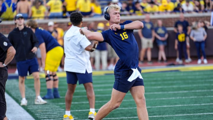 Michigan quarterback Davis Warren (16) warms up before the start before the game against Fresno State at Michigan Stadium in Ann Arbor on Saturday, Aug. 30, 2024.